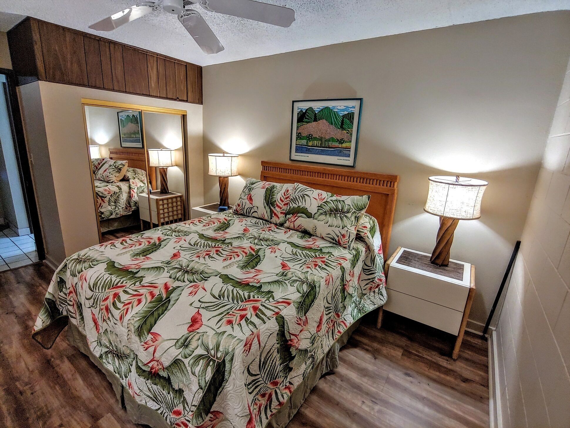 Cozy bedroom with floral bedding and wooden accents.