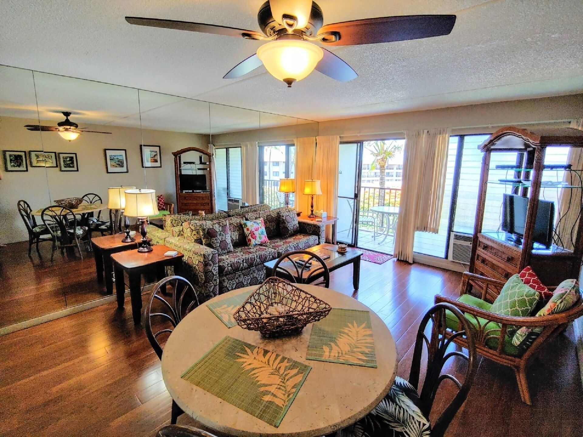 Cozy living room with large mirror and comfy seating.